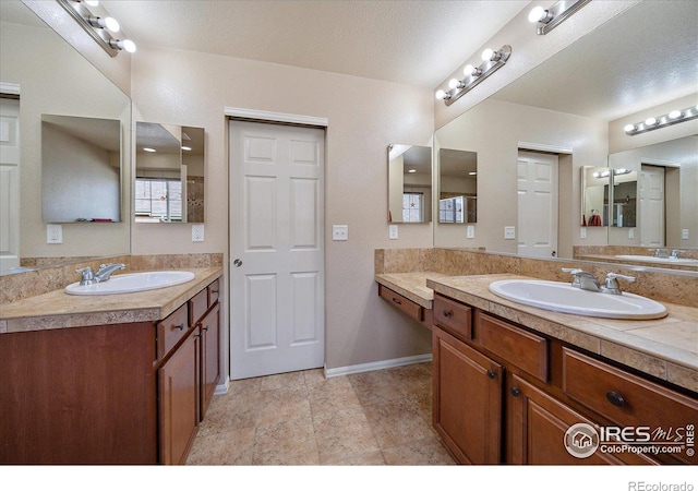 bathroom featuring vanity and a textured ceiling