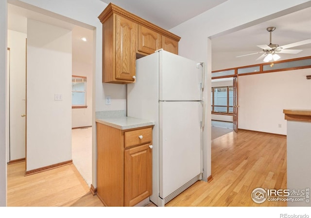 kitchen with ceiling fan, white fridge, and light wood-type flooring