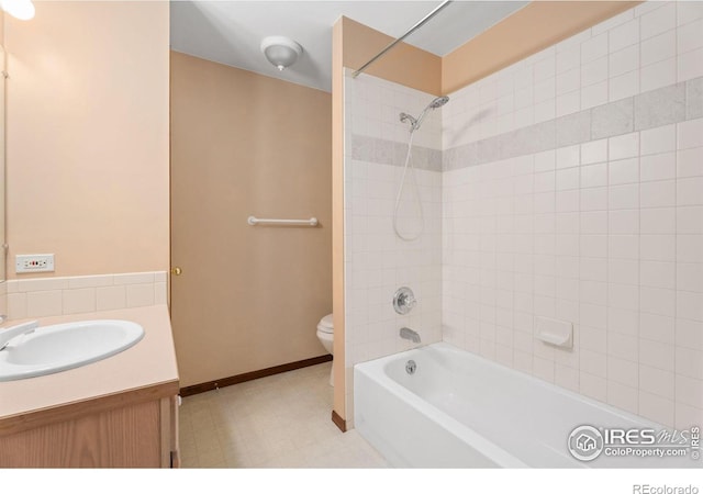 full bathroom with vanity, toilet, and tiled shower / bath