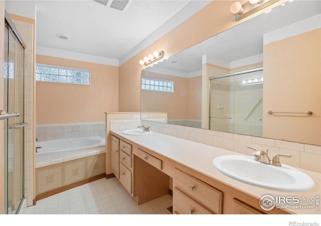 bathroom featuring vanity and independent shower and bath