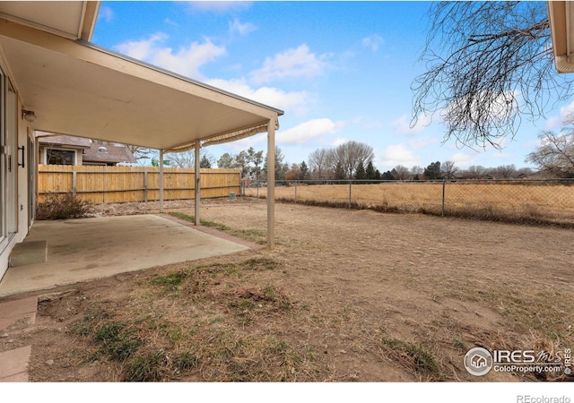 view of yard featuring a patio and a rural view