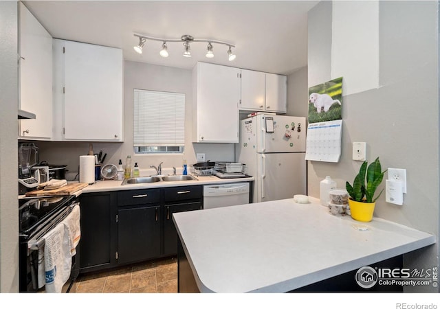 kitchen featuring white cabinets, kitchen peninsula, white appliances, and sink