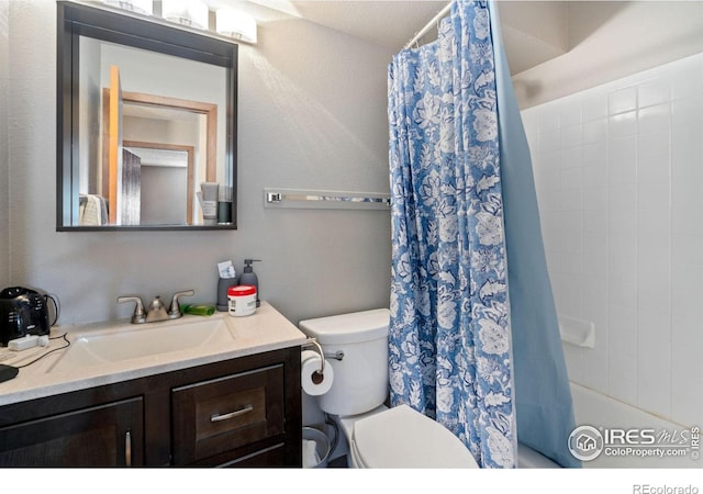 full bathroom with shower / tub combo, vanity, and toilet