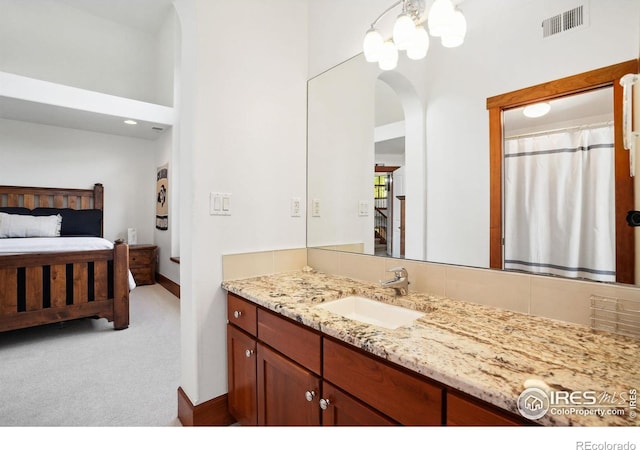 bathroom featuring vanity and a high ceiling