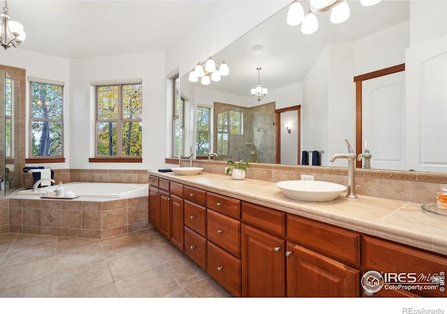 bathroom with a chandelier, shower with separate bathtub, vanity, and tile patterned flooring