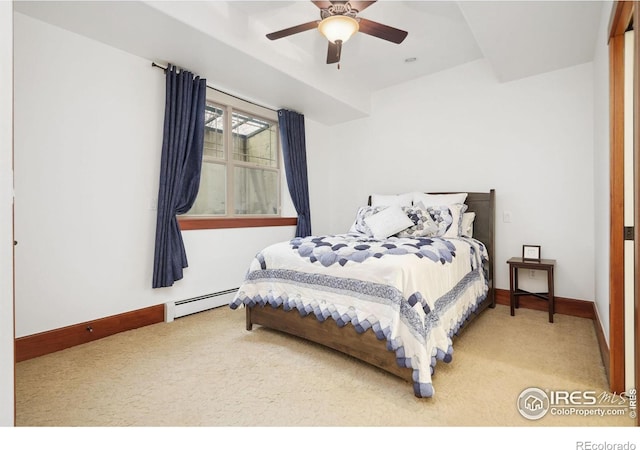 carpeted bedroom with a baseboard radiator and ceiling fan