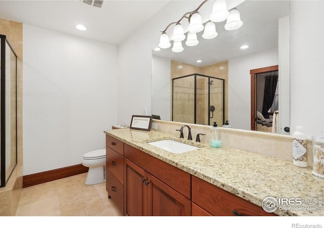 bathroom featuring vanity, a shower with shower door, and toilet