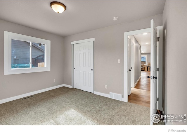 unfurnished bedroom featuring a closet and carpet