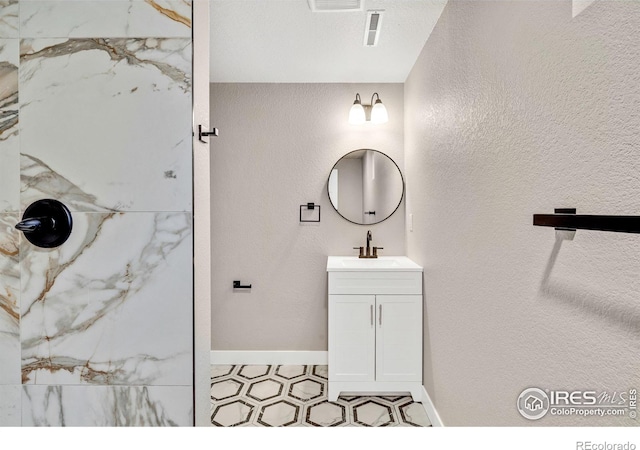 bathroom with vanity and walk in shower