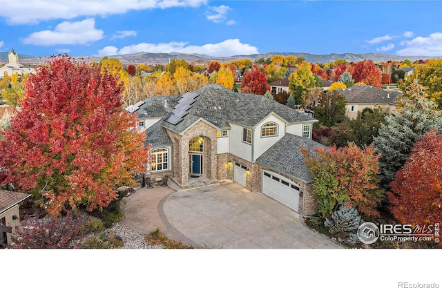 view of front of property featuring a mountain view and a garage