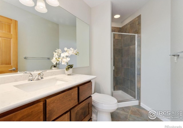 bathroom with tile patterned floors, vanity, toilet, and walk in shower