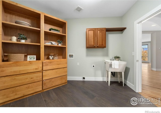 clothes washing area featuring washer hookup, electric dryer hookup, and dark hardwood / wood-style flooring