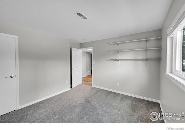 unfurnished bedroom featuring carpet and a closet