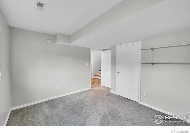 unfurnished bedroom featuring carpet floors and a closet