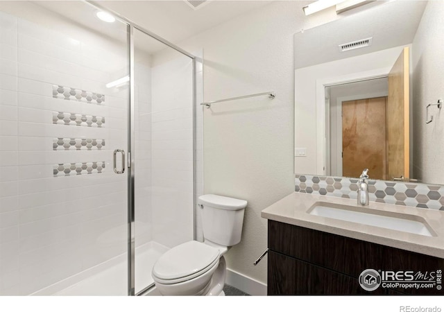 bathroom with vanity, toilet, and walk in shower