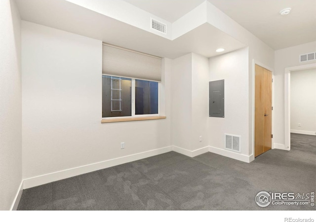 carpeted empty room featuring electric panel