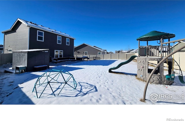 exterior space with a playground and fence