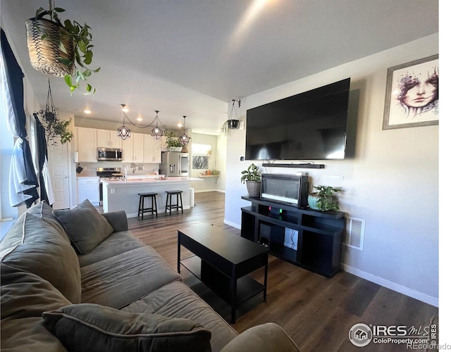 living room featuring dark wood-type flooring