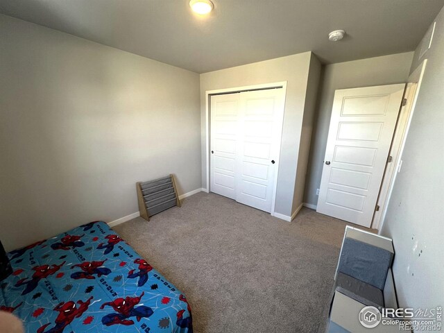 carpeted bedroom with baseboards