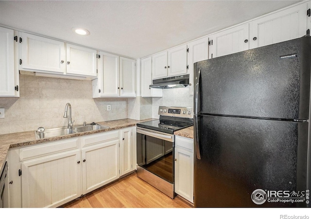 kitchen with white cabinets, appliances with stainless steel finishes, light hardwood / wood-style flooring, and sink