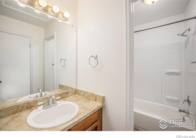 bathroom featuring vanity and  shower combination