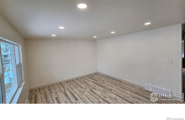 spare room with light wood-type flooring