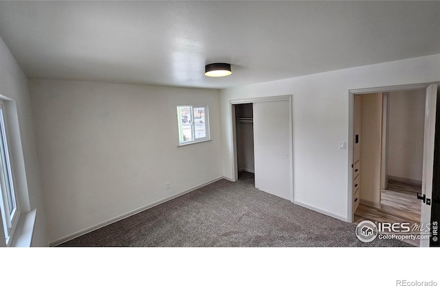 unfurnished bedroom featuring carpet floors and a closet