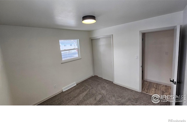 unfurnished bedroom with carpet floors and a closet