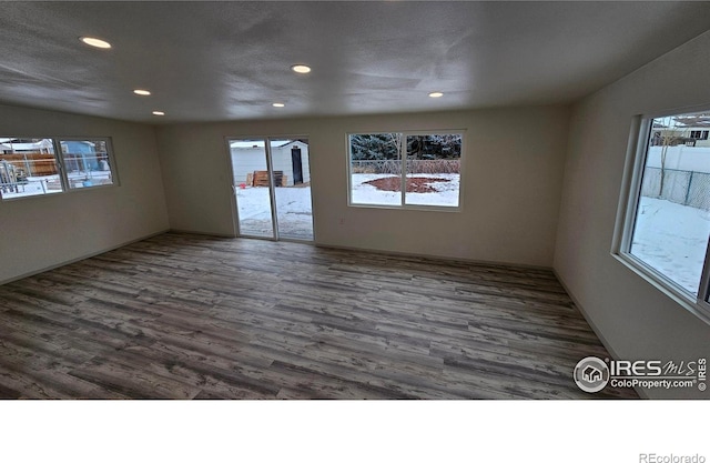 unfurnished room with dark hardwood / wood-style flooring