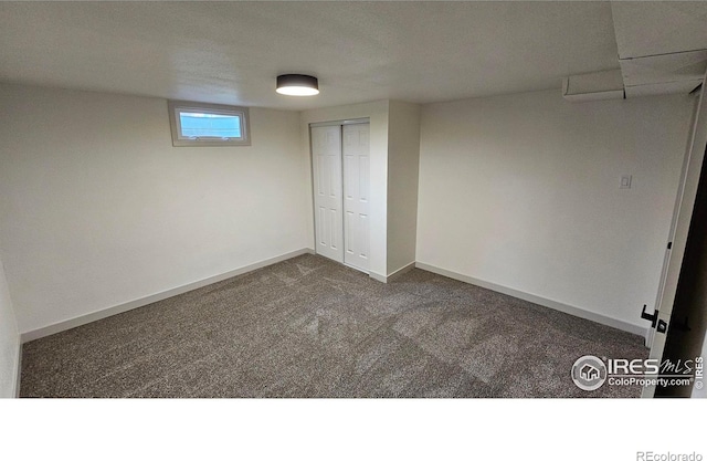 unfurnished bedroom with dark carpet and a closet