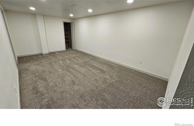 empty room featuring dark colored carpet