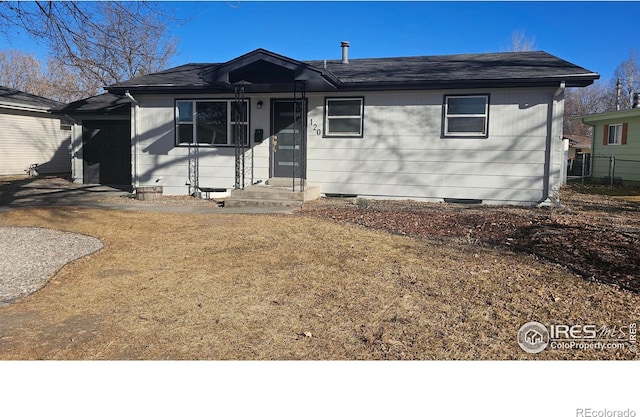 ranch-style home featuring a carport and a front lawn