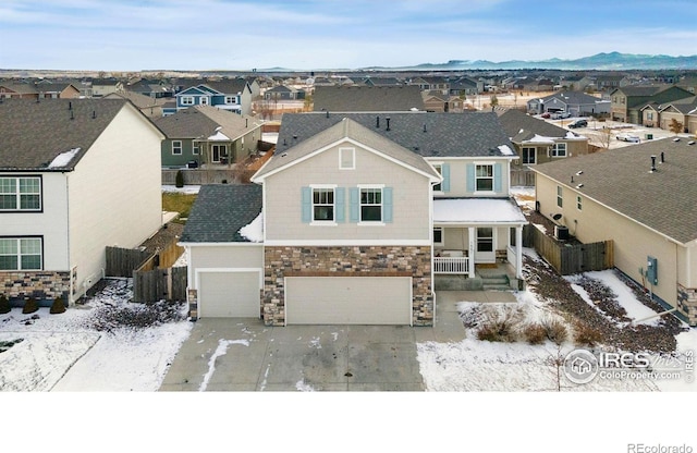 view of front of property featuring a garage and a mountain view