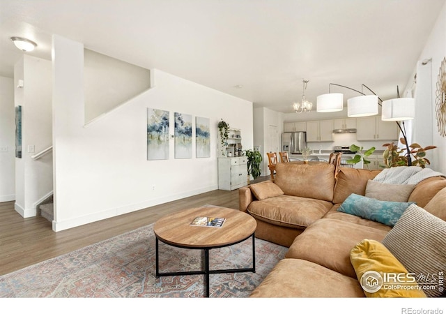 living room featuring a notable chandelier and dark hardwood / wood-style floors