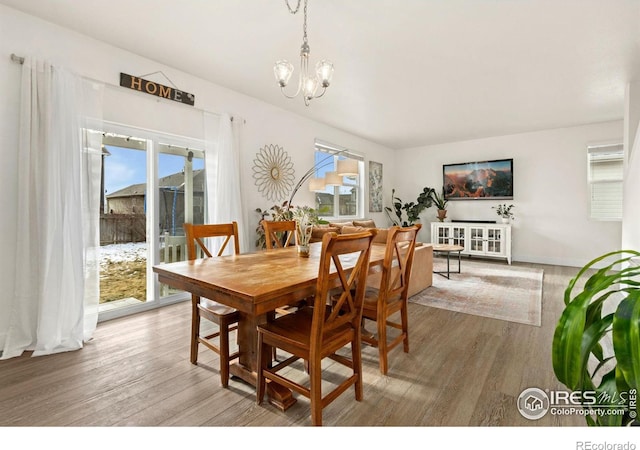 dining space with an inviting chandelier and hardwood / wood-style floors