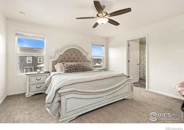 carpeted bedroom with connected bathroom and ceiling fan