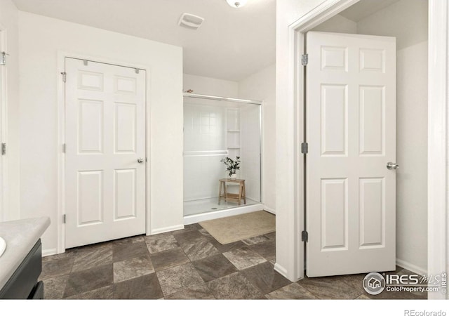 bathroom featuring an enclosed shower and vanity