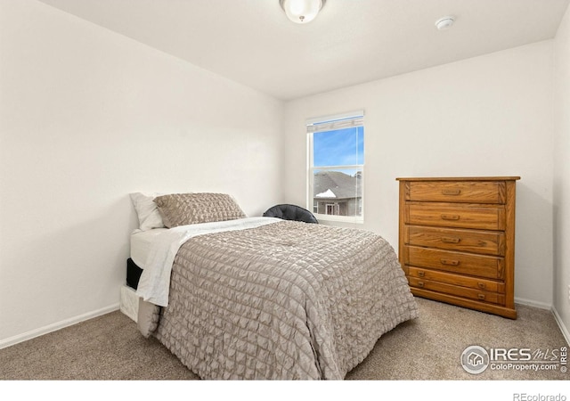 bedroom featuring light colored carpet