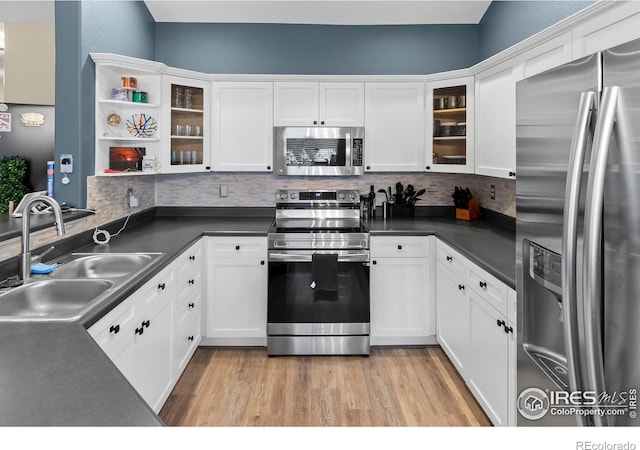 kitchen featuring white cabinets, stainless steel appliances, and sink