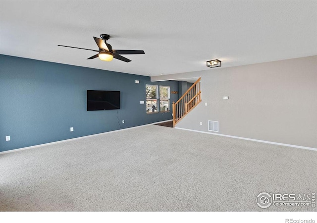 unfurnished living room with ceiling fan and carpet flooring