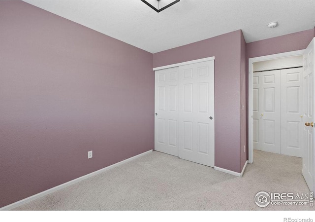 unfurnished bedroom with a closet and light carpet