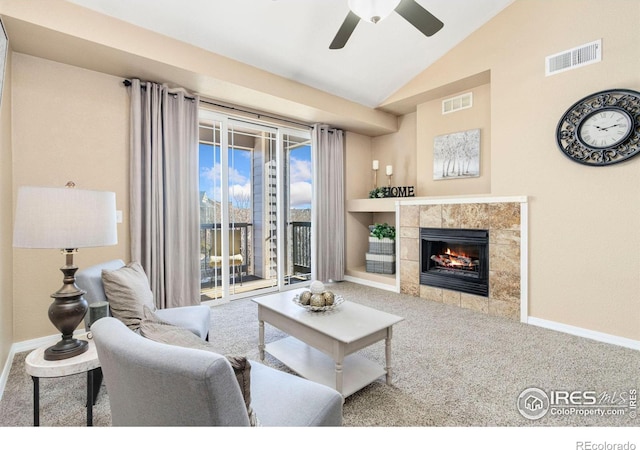 carpeted living room with a fireplace, ceiling fan, and lofted ceiling