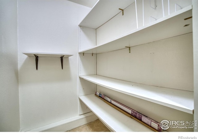 walk in closet featuring light tile patterned floors