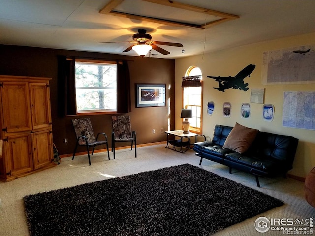 living room with ceiling fan and light colored carpet