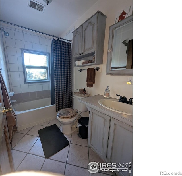 full bathroom featuring toilet, vanity, tile patterned floors, and shower / bath combo with shower curtain