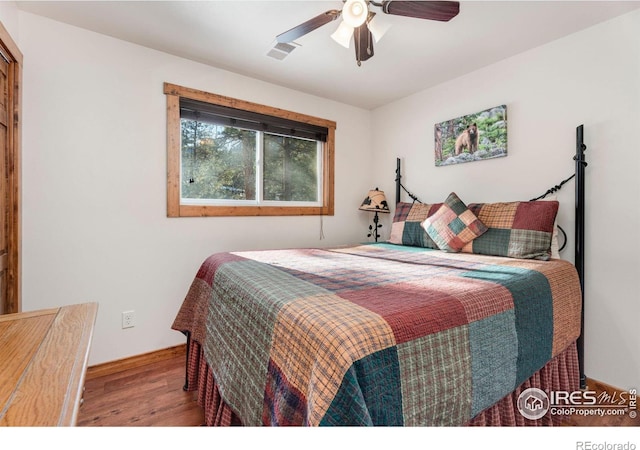 bedroom featuring hardwood / wood-style flooring and ceiling fan