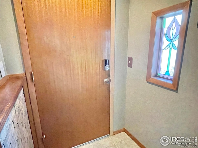 entryway with light tile patterned floors