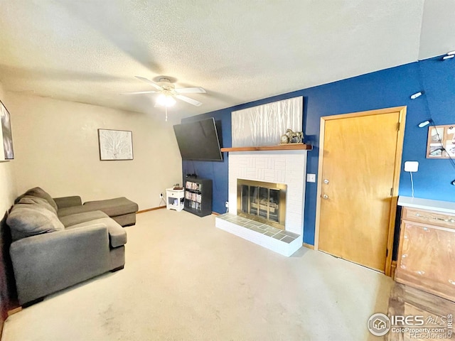 living room featuring ceiling fan, carpet, a textured ceiling, and a brick fireplace