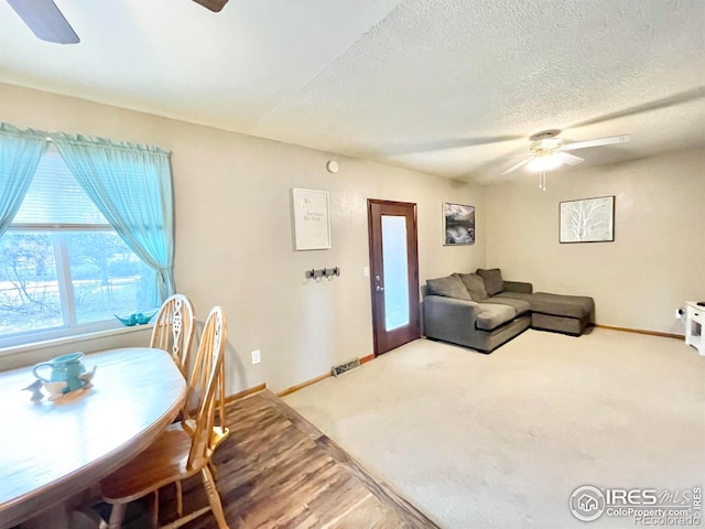 living room with french doors, a textured ceiling, and carpet floors