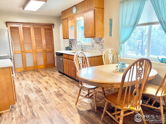 dining area featuring sink and light hardwood / wood-style flooring